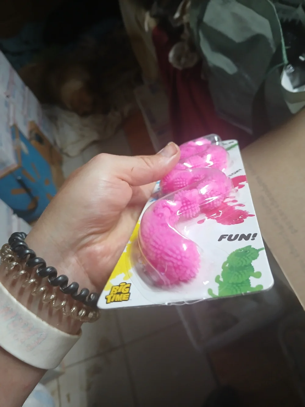 a pink stretchy caterpillar fidget toy with bumpy textures, made by Big Time Toy